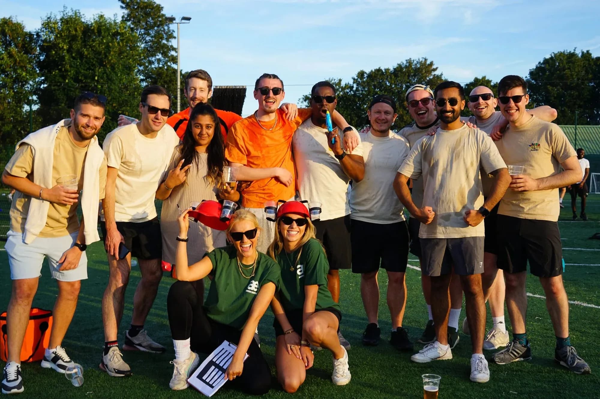 A team celebrating outdoors on a sports field